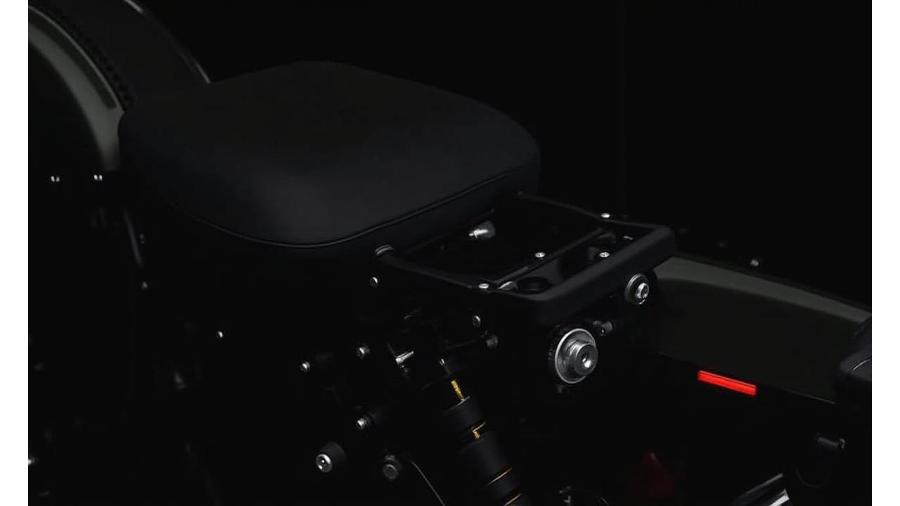 Detailed view of a motorcycle bag mounting system securely attached to a bike frame.